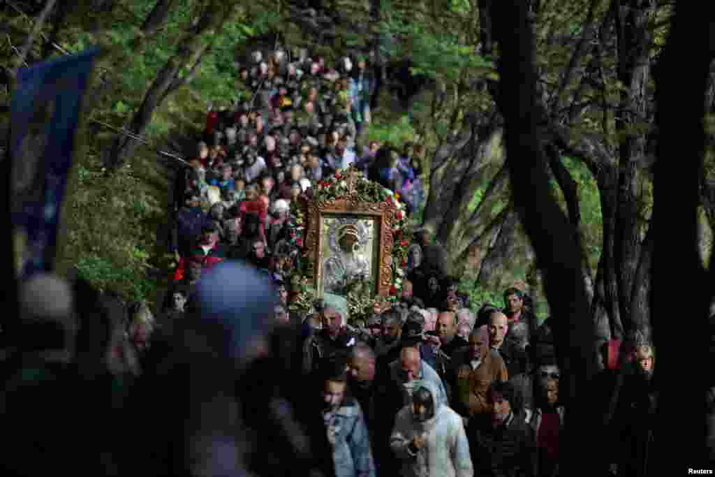 Orthodox Christians carry an icon of the Virgin Mary during a parade marking Easter near Bachkovo monastery, Bulgaria.