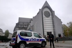 French police officers stand guard outside Notre Dame church in Lille, northern France, Nov. 1, 2020.