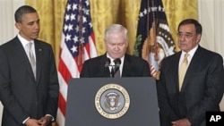 Outgoing Defense Secretary Robert Gates, center, pauses as he speaks about US troops, as President Barack Obama and Defense Secretary-nominee Leon Panetta listen, in the East Room of the White House in Washington, DC, April 28, 2011