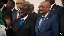 President Robert Mugabe and South African president Jacob Zuma, whose country has just sold some Zimbabwe property.