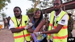 Paramedics help a student who was injured during an attack by Somalia's al-Qaida-linked al-Shabab gunmen at Garissa University College, Kenya, April 2, 2015. 