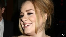 British singer Adele greets her fans after her concert at Radio City Music Hall on Nov. 17, 2015 in New York. Tickets for Adele's first concert tour of North America in five years sold out within minutes for venues on the U.S. East Coast on Dec. 17, 2015.