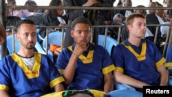 Benjamin Zalman Polun, left, Marcel Malanga, middle, and Tyler Thompson, American citizens suspected to be involved in an attempted coup in Congo, wait for the final verdict during their trial in Kinshasa, Democratic Republic of the Congo, Sept. 13, 2024.