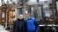 Ukrainian Energy Minister German Galushchenko, left, and International Atomic Energy Agency Director General Rafael Grossi, right, visit an energy infrastructure facility damaged during Russian missile and drone strikes in an undisclosed location in Ukraine, Feb. 4, 2025.