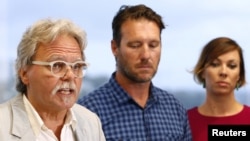 John Ruszczyk, the father of Justine Damond, speaks as he stands next to his son Jason Ruszczyk and Jason's wife Katarina, during a media conference in Sydney, Dec. 21, 2017.