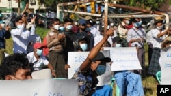 FILE - Protesters shout slogans as they take part in a rally to condemn results of Nov. 8 general election, Nov. 20, 2020, in Yangon, Myanmar.