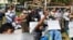 FILE - Protesters shout slogans as they take part in a rally to condemn results of Nov. 8 general election, Nov. 20, 2020, in Yangon, Myanmar.