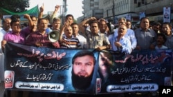FILE - Pakistani journalists in Karachi shout slogans condemning the killing of journalists, Sept. 9, 2015. 