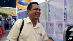 FILE - Political analyst Kem Ley smiles as he celebrated the 67th anniversary to commemorate the Kampuchea Krom territory's return to Vietnam by the French government, at Chroy Changvar, in Phnom Penh, Cambodia, June 4, 2016. Kem Lay was shot dead July 10