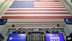 Executives with Medley Capital Corporation attend the opening bell at the New York Stock Exchange, which is being bought by Deutsche Boerse, February 15, 2011