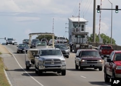 People drive over a drawbridge in Wrightsville Beach, N.C., as they evacuate the area in advance of Hurricane Florence, Sept. 11, 2018.