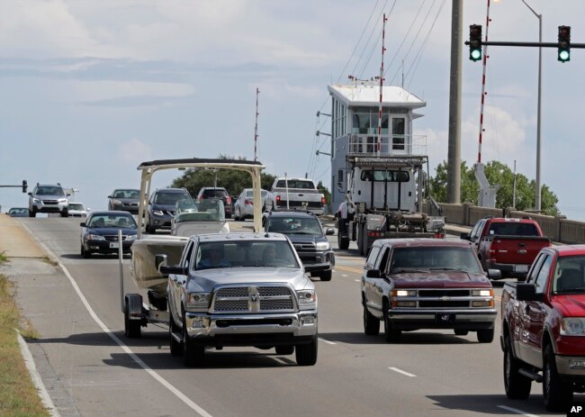 People drive over a drawbridge in Wrightsville Beach, N.C., as they evacuate the area in advance of Hurricane Florence, Sept. 11, 2018.