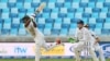 Pakistan's Asad Shafiq bats as England's Jos Buttler looks on during a Pakistan-England match at Dubai International Stadium, United Arab Emirates on Oct. 22, 2105.