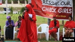 A member of the Abuja "Bring Back Our Girls" protest group addresses a sit-in demonstration organized by the group at the Unity Fountain in Abuja, Nigeria, June 23, 2014. 