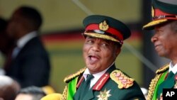 FILE: Constantino Chiwenga and army commander Philip Valerio Sibanda smile during the presidential inauguration ceremony in Harare, Zimbabwe, Nov. 24, 2017.