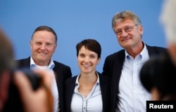 FILE - (L-R) Berlin top candidate of the anti-immigration party Alternative for Germany (AfD) Georg Pazderski, AfD Germany co-leaders Frauke Petri and Joerg Meuthen pose after a news conference in Berlin, Sept. 19, 2016.