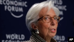Christine Lagarde, Managing Director of the International Monetary Fund (IMF), addresses a news conference on the eve of the World Economic Forum, WEF, in Davos, Jan. 22, 2018. 