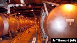 FILE - Giant containment cylinders used to move deadly chemical weapons from storage igloos to an incinerator inside the Umatilla Chemical Weapons Disposal Facility outside Hermiston, Oregon, June 8, 2004