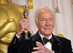 FILE - Christopher Plummer holds his Oscar for best actor in a supporting role for "Beginners" in the press room at the 84th Annual Academy Awards, Feb. 26, 2012, in Hollywood, Calif.
