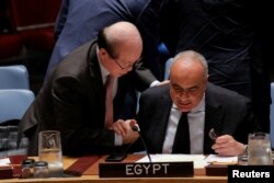 Chinese representative Liu Jieyi speaks with Egypt Ambassador Amr Aboulatta, right, after a vote by the Security Council at the United Nations, July 29, 2016.