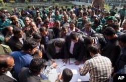 Bangladeshi elections officials gather to collect voting material at a distribution center on the eve of the general elections in Dhaka, Bangladesh, Saturday, Dec. 29, 2018.