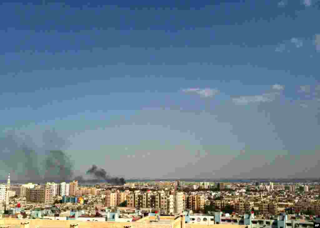 Smoke rises over the skyline in the Qaboun neighborhood of Damascus, Syria, during shelling by Syrian government forces, July 19, 2012.