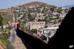 The international border cuts through Nogales, Sonora, Mexico, right, and Nogales, Arizona, as seen April 9, 2018, from Nogales.