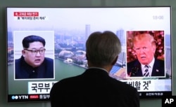 FILE - A man watches a TV screen showing file footage of U.S. President Donald Trump, right, and North Korean leader Kim Jong Un during a news program at the Seoul Railway Station in Seoul, South Korea, May 16, 2018.