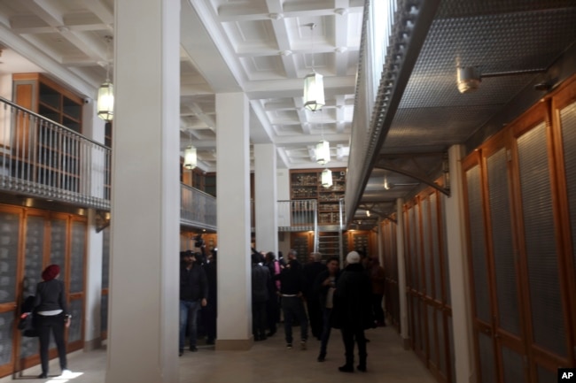 Officials walk around the main hall of the newly opened Saint Catherine library in South Sinai, Egypt, Dec. 16, 2017. The inauguration ceremony comes after three years of restoration work on the work on the eastern side of the library that houses the world’s second largest collection of early codices and manuscripts, outnumbered only by the Vatican Library.