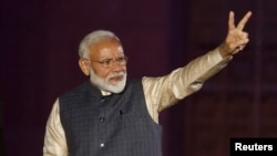 Indian Prime Minister Narendra Modi gestures toward his supporters after the election results at Bharatiya Janata Party (BJP) headquarter in New Delhi, India, May 23, 2019.