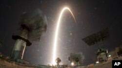 In this photo taken with long time exposure the Soyuz-FG rocket booster with Soyuz MS-08 space ship carrying a new crew to the International Space Station, ISS, blasts off at the Russian leased Baikonur cosmodrome, Kazakhstan, Wednesday, March 21, 2018. The Russian rocket carries Russian cosmonaut Oleg Artemyev, and U.S. astronauts Richard Arnold and Andrew Feustel. (AP Photo/Dmitri Lovetsky)