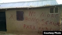 Before they destroy a building in Abuja, Nigeria, authorities mark the building with a red 'X' and write a few words. 