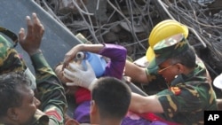 Rescuers carry a survivor pulled out from the rubble of a building that collapsed in Saver, near Dhaka, Bangladesh, May 10, 2013.