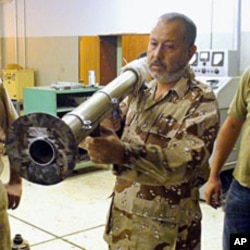 A tea towel is used as padding on an improvised rocket launcher, Benghazi, June 23, 2011