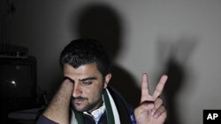 Zaher Al Hariri, speaks to the media in Amman, Jordan, March 15, 2012, describing how his right hand was cut off by Syrian security forces after he went to a state hospital in Syria's Deraa city to receive treatment after a bullet penetrated his fingers w