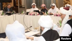 FILE - Undated handout picture of US, Taliban, and Qatar officials during a meeting for peace talks in Doha, Qatar. (Qatari Foreign Ministry) 