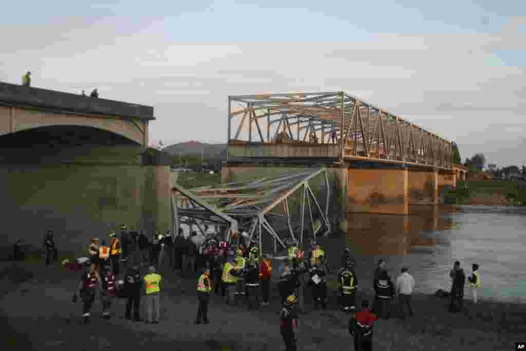 Emergency personnel gather at the collapsed Interstate 5 bridge, Mount Vernon, Washington, May 23, 2013.