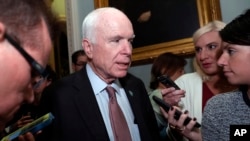 Sen. John McCain, R-Ariz., speaks with reporters on Capitol Hill, Sept. 19, 2017, in Washington. McCain says that President Donanld Trump is putting U.S. national security at risk when he takes the word of Russian President Vladimir Putin over that of the American intelligence community.