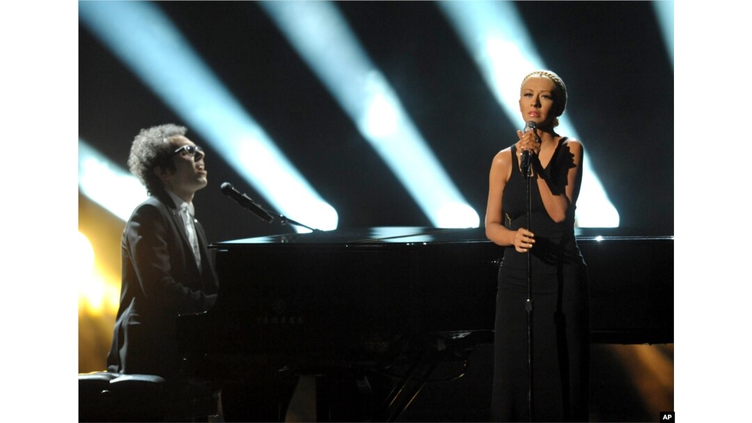 Ian Axel, left, of A Great Big World performs on stage with Christina Aguilera at the American Music Awards at the Nokia Theatre L.A. Live on Nov. 24, 2013, in Los Angeles.