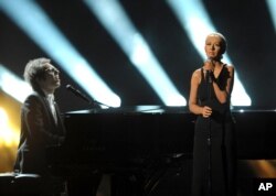 Ian Axel, left, of A Great Big World performs on stage with Christina Aguilera at the American Music Awards at the Nokia Theatre L.A. Live on Nov. 24, 2013, in Los Angeles.