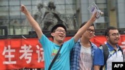 A student pose for a photo after taking the 2014 college entrance exam of China.
