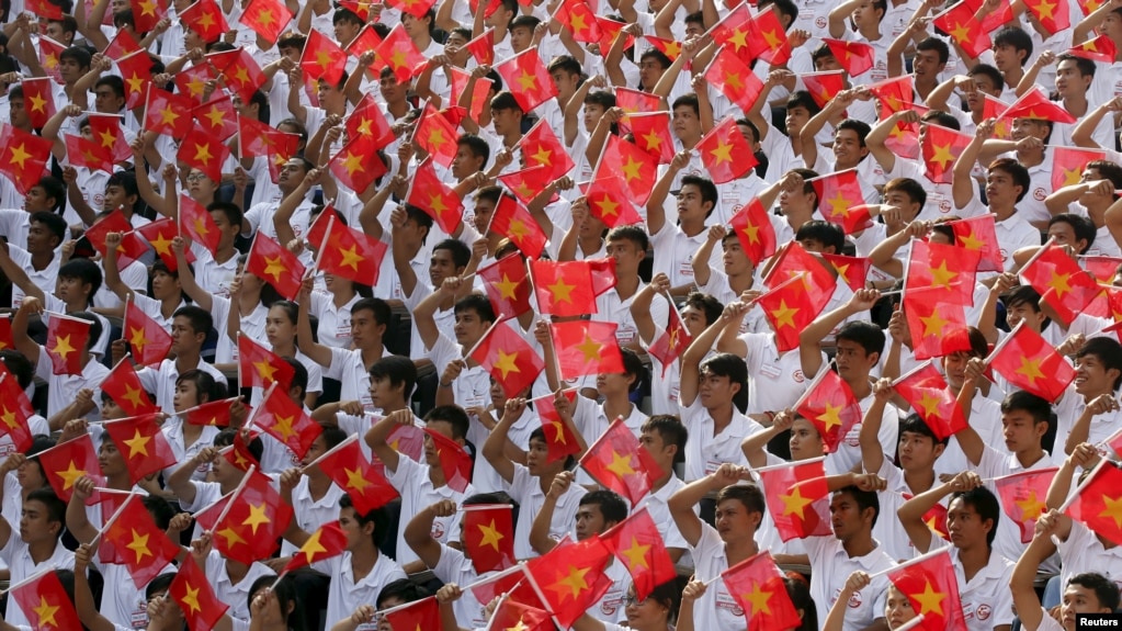 Students wave the Vietnamese national flag