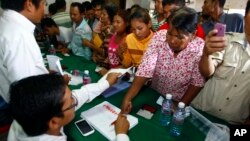 Supporters of National Rescue Party gather to give their thumbprint as they complain that their names were not in the voting lists in July 28 election, July 31, 2013.