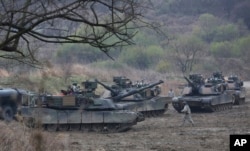 FILE - U.S. Army tanks conduct a military exercise in Paju, South Korea, near the border with North Korea, April 14, 2017.