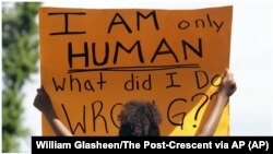 USA, Rylie Blue holds a sign during a Black Lives Matter march and rally Sunday, May 31, 2020, in Oshkosh, Wis. 