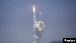 A Raytheon Co. ‘kill vehicle’ separates from a rocket and hits a dummy incoming warhead in a test at Vandenberg Air Force Base in California, June 22, 2014. 