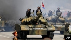 FILE - Soldiers in tanks are paraded across Kim Il Sung Square during a military parade, April 15, 2017, in Pyongyang, North Korea. The United Nations is investigating at least seven African countries accused of receiving military assistance from North Ko