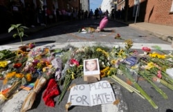 FILE - A makeshift memorial of flowers and a photo of victim, Heather Heyer, sits in Charlottesville, Virginia, Aug. 13, 2017.