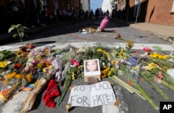A makeshift memorial of flowers and a photo of victim, Heather Heyer, sits in Charlottesville, Virginia, Aug. 13, 2017.