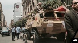 FILE - Soldiers atop military vehicles are seen patrolling near a church in downtown Cairo, Egypt, April 10, 2017.